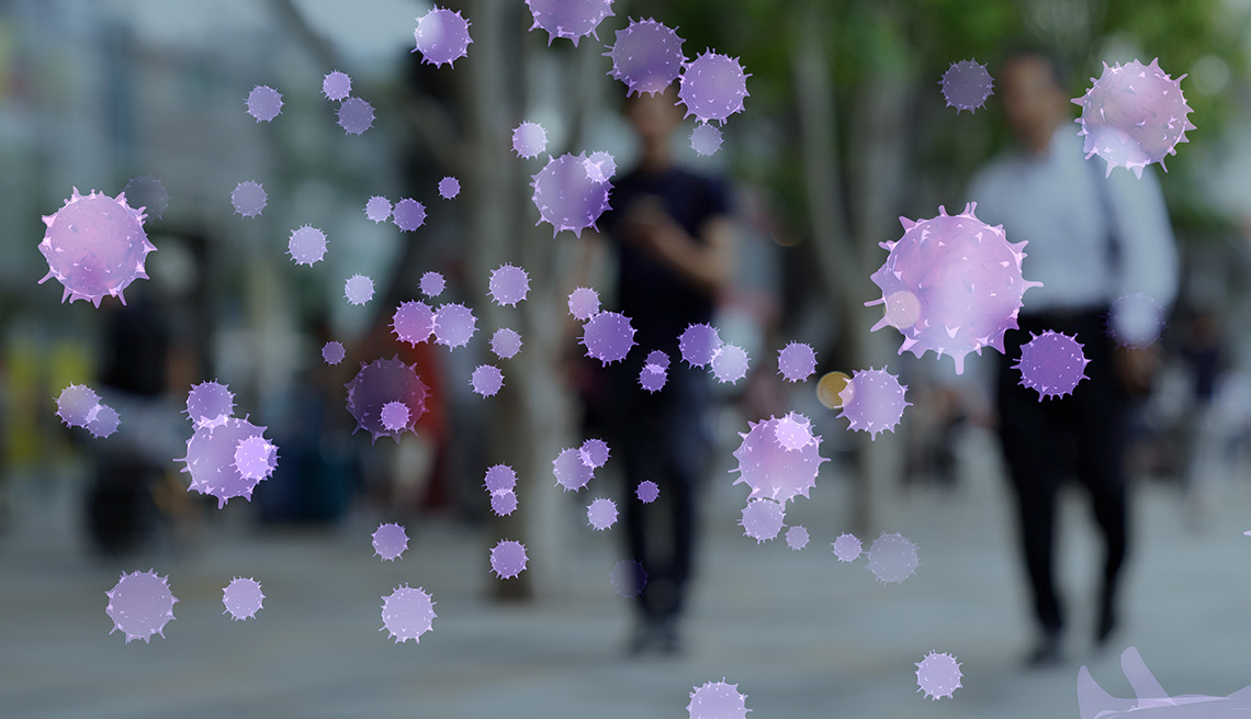 Images of virus floating in front of a blurry photograph of people walking