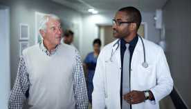 A doctor helps his patient understand Medicare and explains all his questions and addresses his concerns.