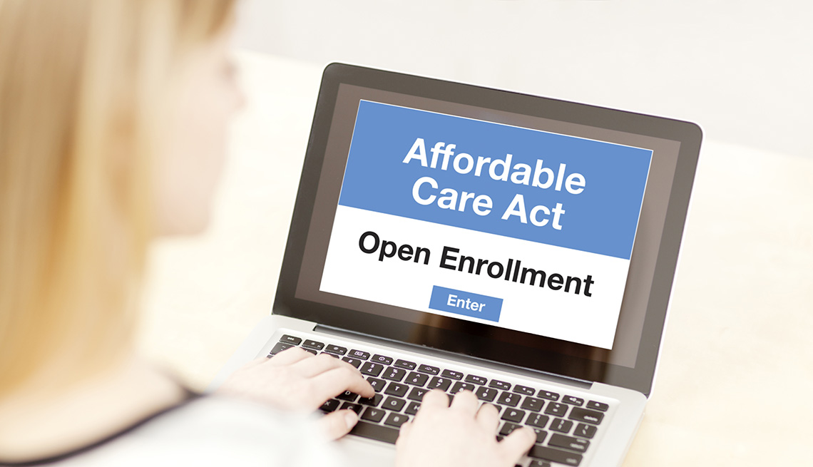 woman using a laptop to fill out affordable care act application during open enrollment