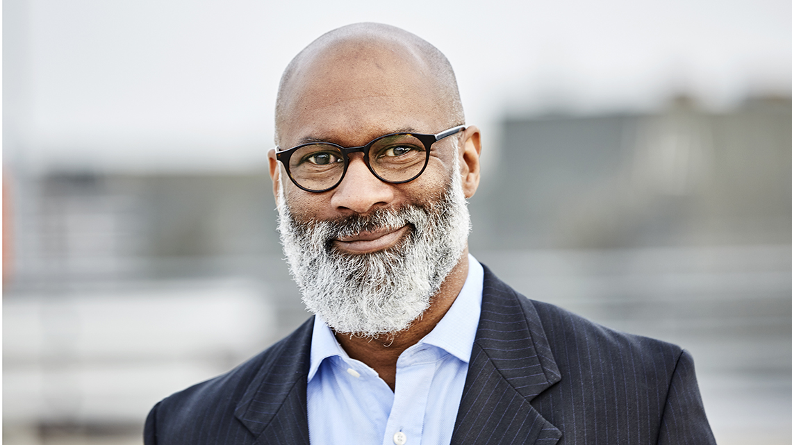 Mature, bearded, African American man with black frame glasses